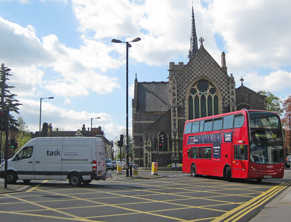 Buses and other traffic pirouette in front of St John's