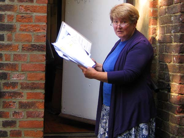 Dr Gillian Gear, archivist, examines the plans for a three-storey extension