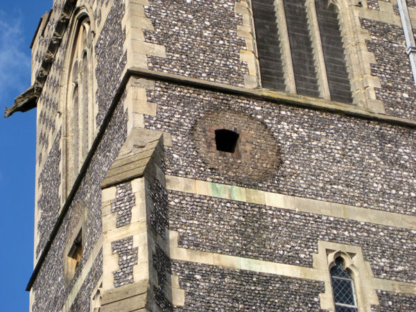 The south facing hole and the small window for the clock dial facing west.