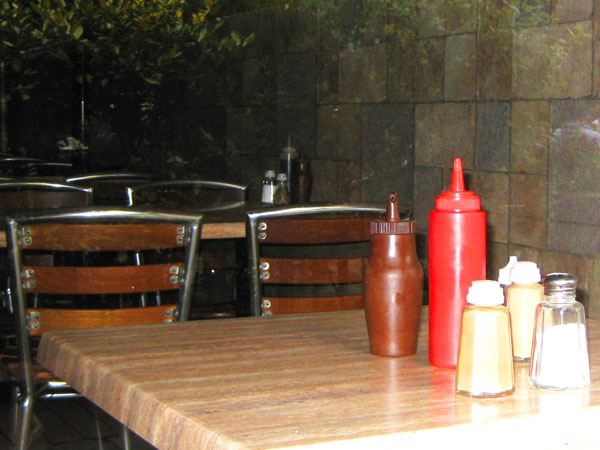 Salt and sauce bottles still on tables