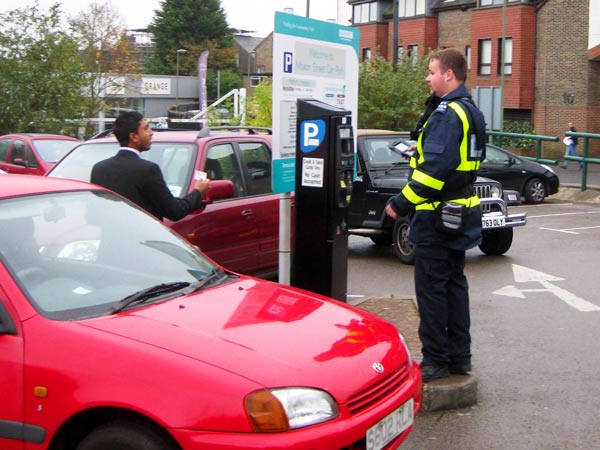 Parking enforcement officer tells a motorist the meter in Moxon Street car park prints a ticket for an hour’s free parking