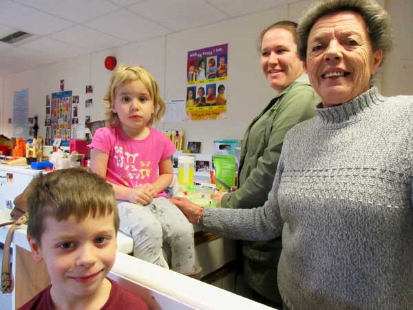 Smiles for the camera at the Valley Pre-School’s open day. L to R: Luke, Erim and their mother Mrs Sarah Mulvihill and Mrs Wendy Oliver, the longest serving member of staff