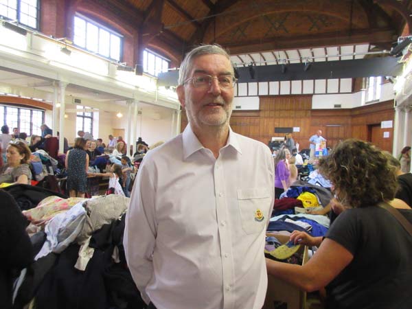 Alan King, head leader of 1st Barnet Boys’ Brigade and Girls’ Association, taking command as bargain hunters crowd around during the summer jumble sale