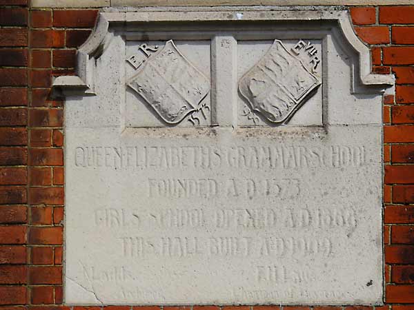 The stone plaque on the hall wall