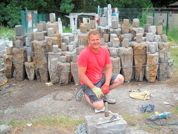 Finchley sculptor Drew Edwards working on Children of the Mediterranean, his donated sculpture outside Middlesex University