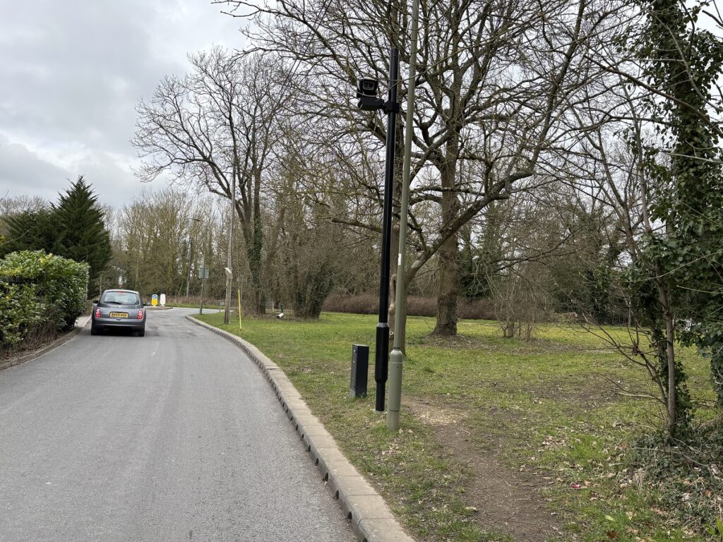 Volunteer litter picker at Arkley finds unexpected item -- an abandoned ULEZ camera pole lying on a grass verge